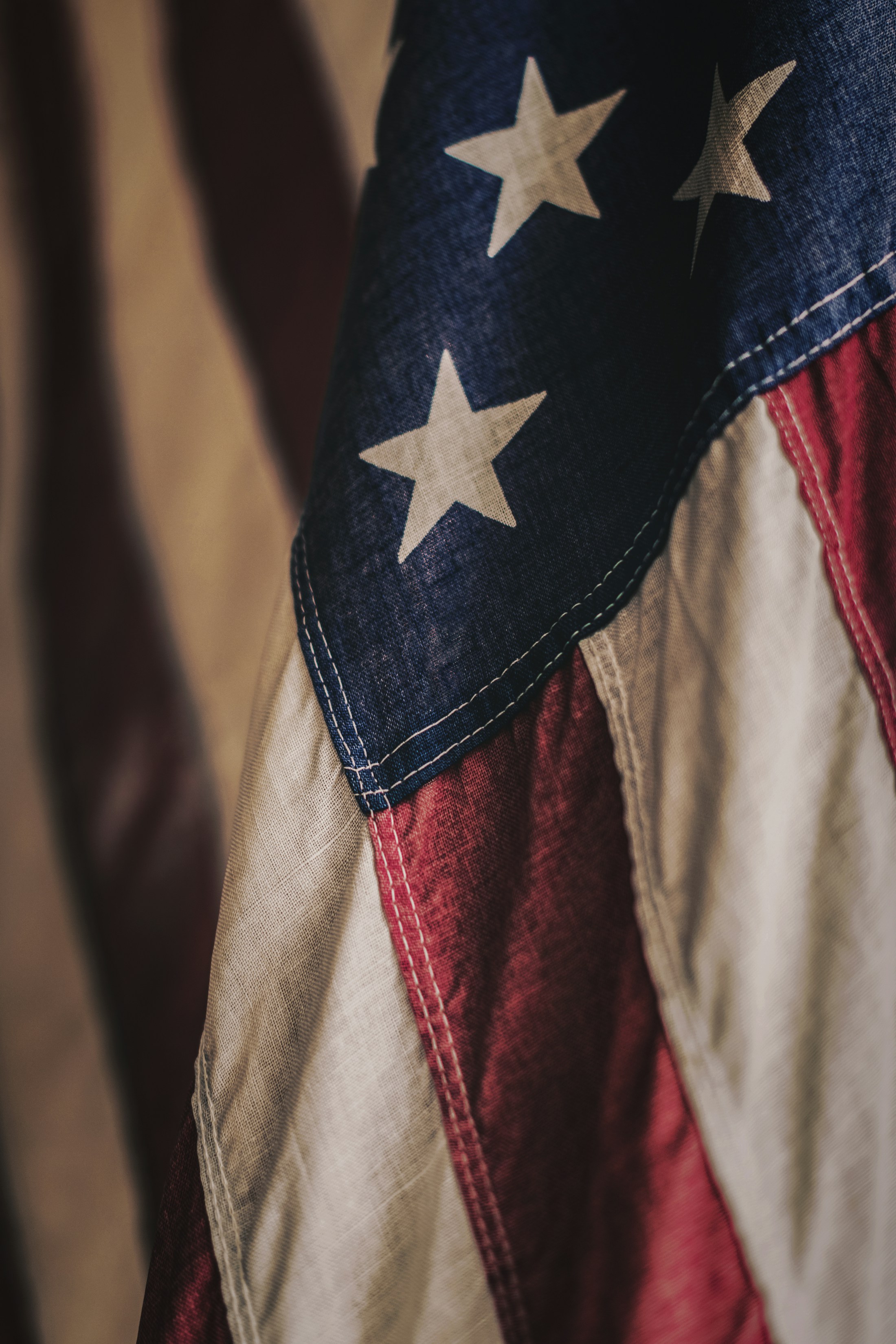 Close-up photograph of a weathered American flag